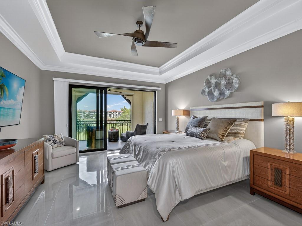 16371 Viansa Way, Unit 201 Naples, FL 34110 - Photo 12 of 42 a bedroom with a large bed and a large window