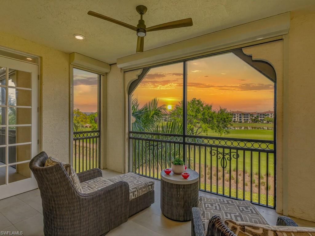 16371 Viansa Way, Unit 201 Naples, FL 34110 - Photo 14 of 42 a living room with furniture and a floor to ceiling window
