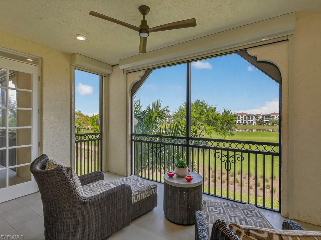 16371 Viansa Way, Unit 201 Naples, FL 34110 - Photo 15 of 42 a living room with furniture and a floor to ceiling window