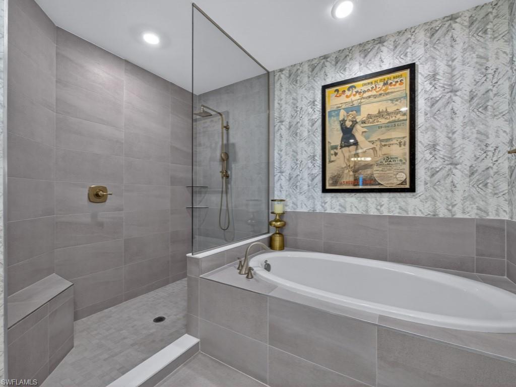 16371 Viansa Way, Unit 201 Naples, FL 34110 - Photo 17 of 42 a white bath tub sitting next to a shower