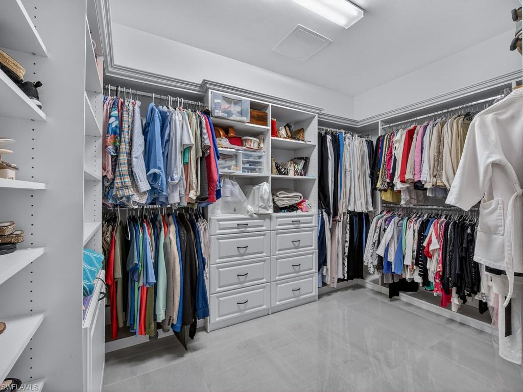 16371 Viansa Way, Unit 201 Naples, FL 34110 - Photo 18 of 42 a view of walk in closet with clothes