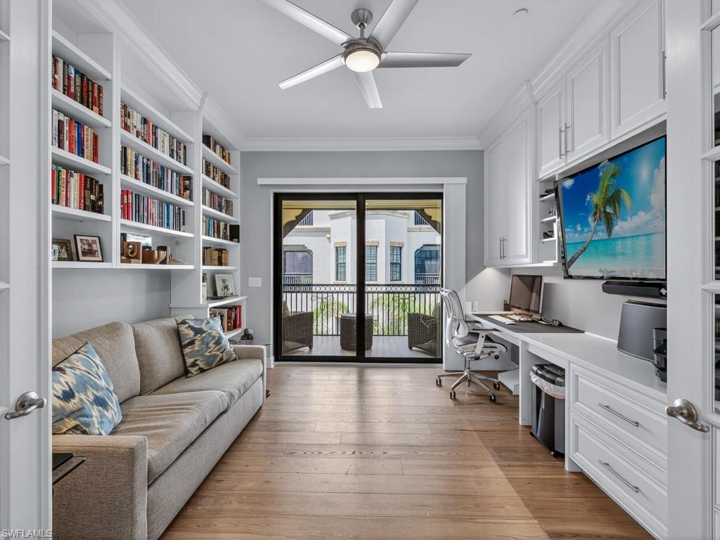 16371 Viansa Way, Unit 201 Naples, FL 34110 - Photo 19 of 42 a living room with furniture and a flat screen tv
