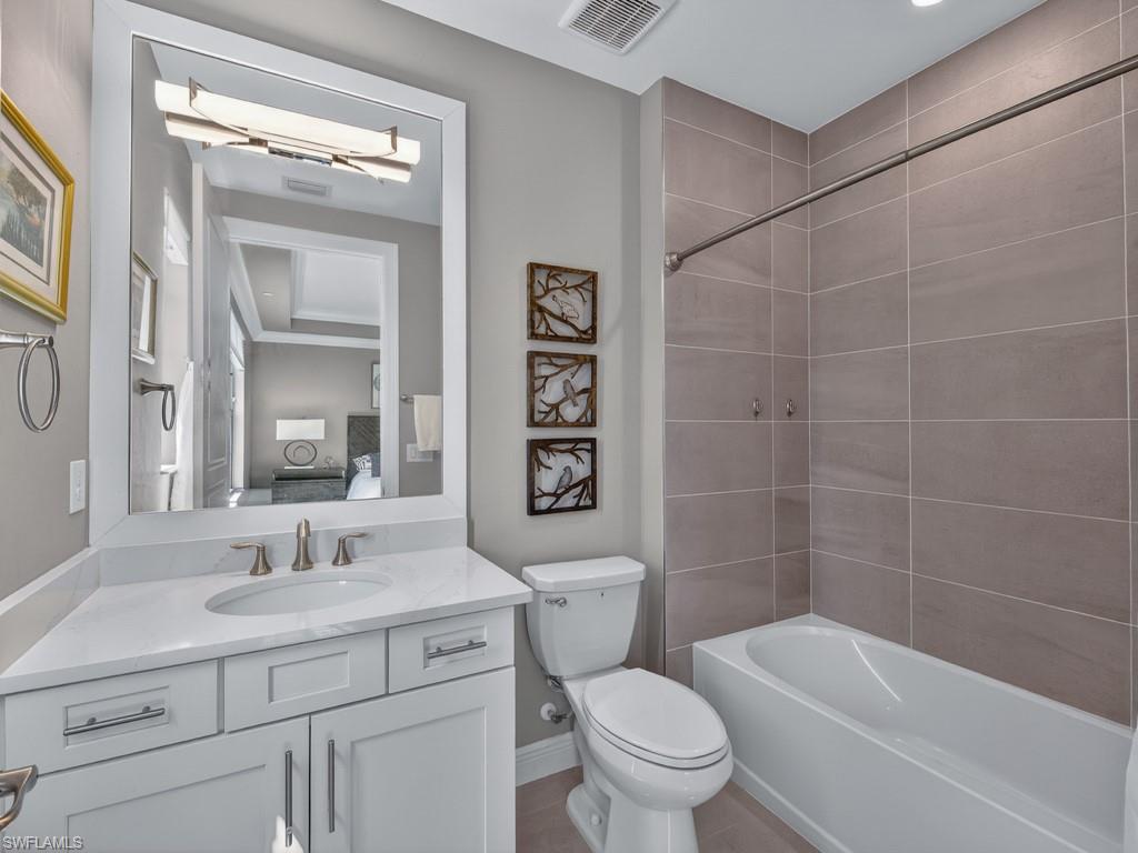 16371 Viansa Way, Unit 201 Naples, FL 34110 - Photo 22 of 42 a bathroom with a sink a toilet and shower