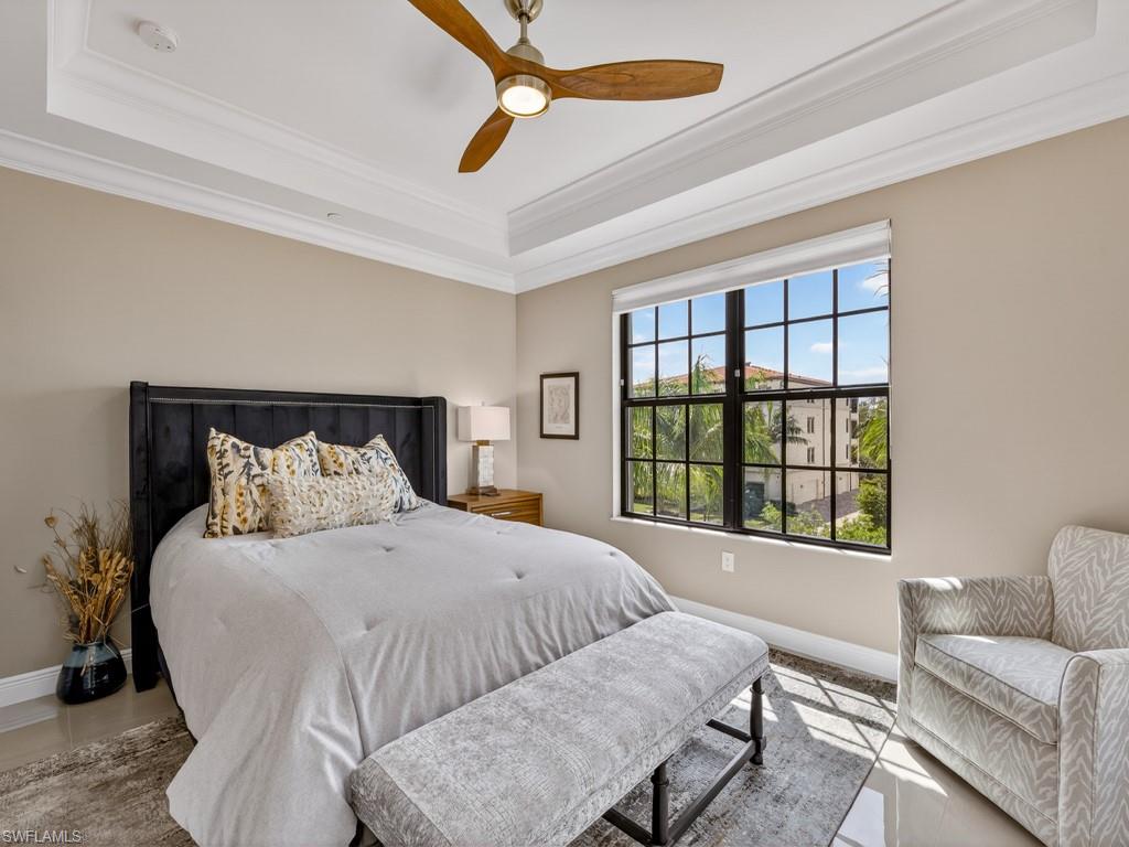16371 Viansa Way, Unit 201 Naples, FL 34110 - Photo 23 of 42 a bedroom with a large bed and a couch
