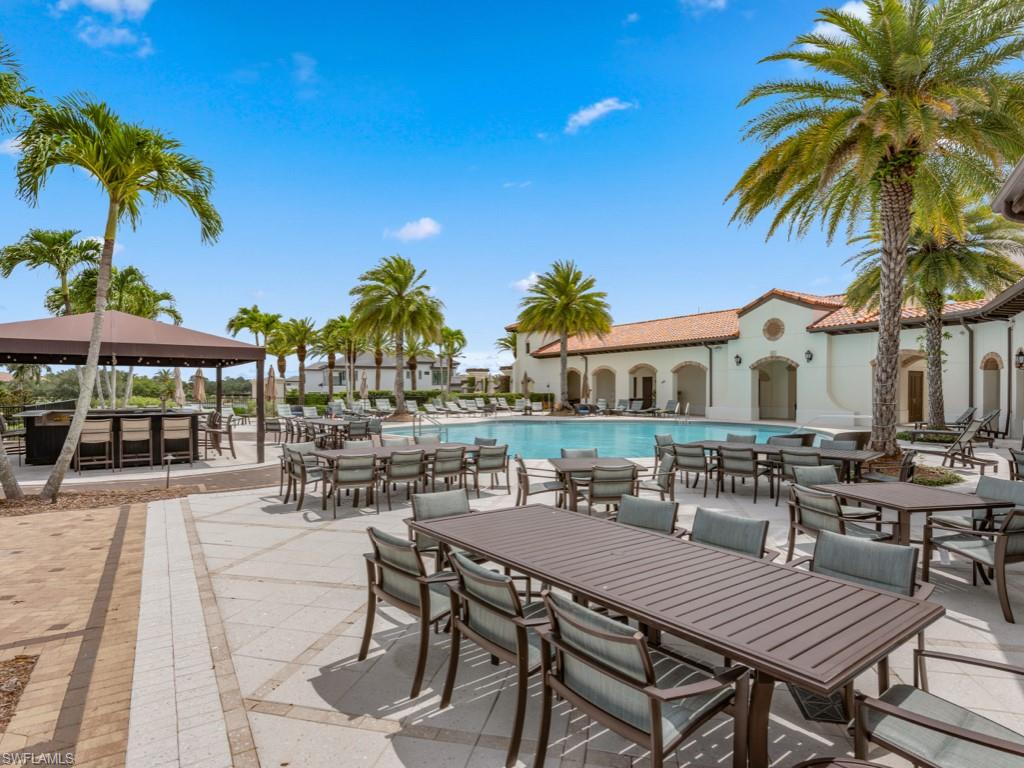 16371 Viansa Way, Unit 201 Naples, FL 34110 - Photo 41 of 42 a view of a patio with a table and chairs