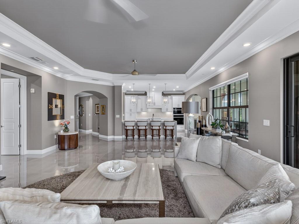 16371 Viansa Way, Unit 201 Naples, FL 34110 - Photo 5 of 42 a living room with furniture and a table