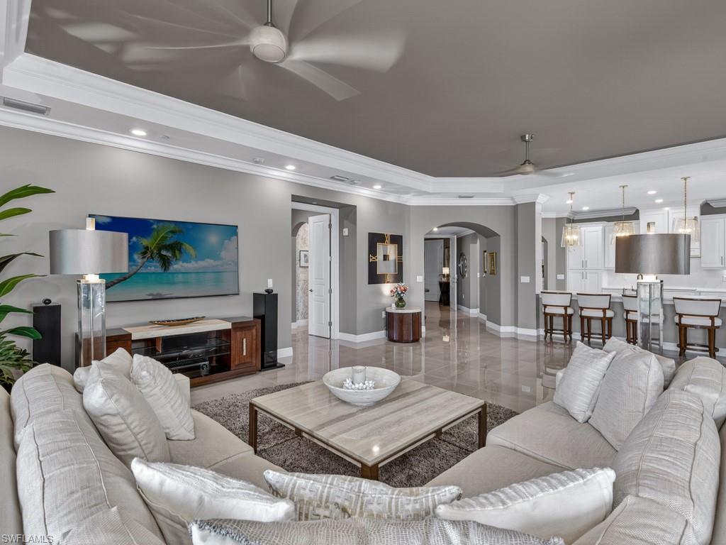 16371 Viansa Way, Unit 201 Naples, FL 34110 - Photo 6 of 42 a living room with furniture and a fireplace
