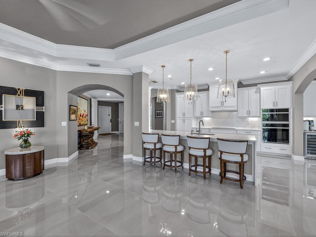 16371 Viansa Way, Unit 201 Naples, FL 34110 - Photo 7 of 42 a large kitchen with a table and chairs