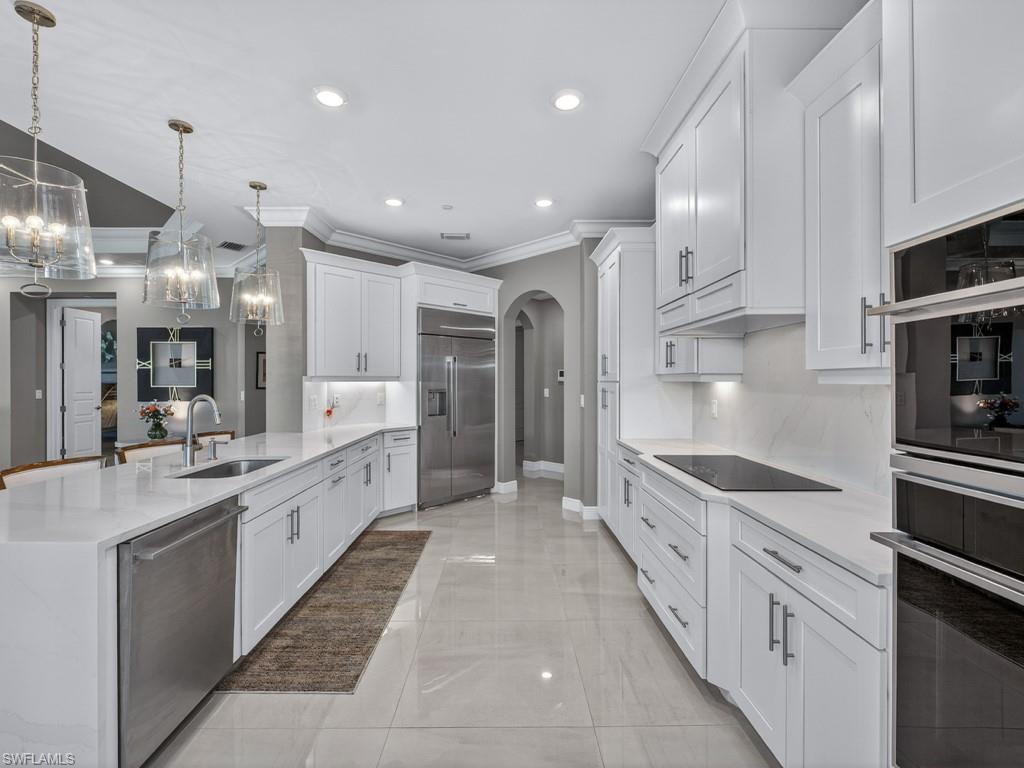 16371 Viansa Way, Unit 201 Naples, FL 34110 - Photo 9 of 42 a large white kitchen with stainless steel appliances lots of counter top space