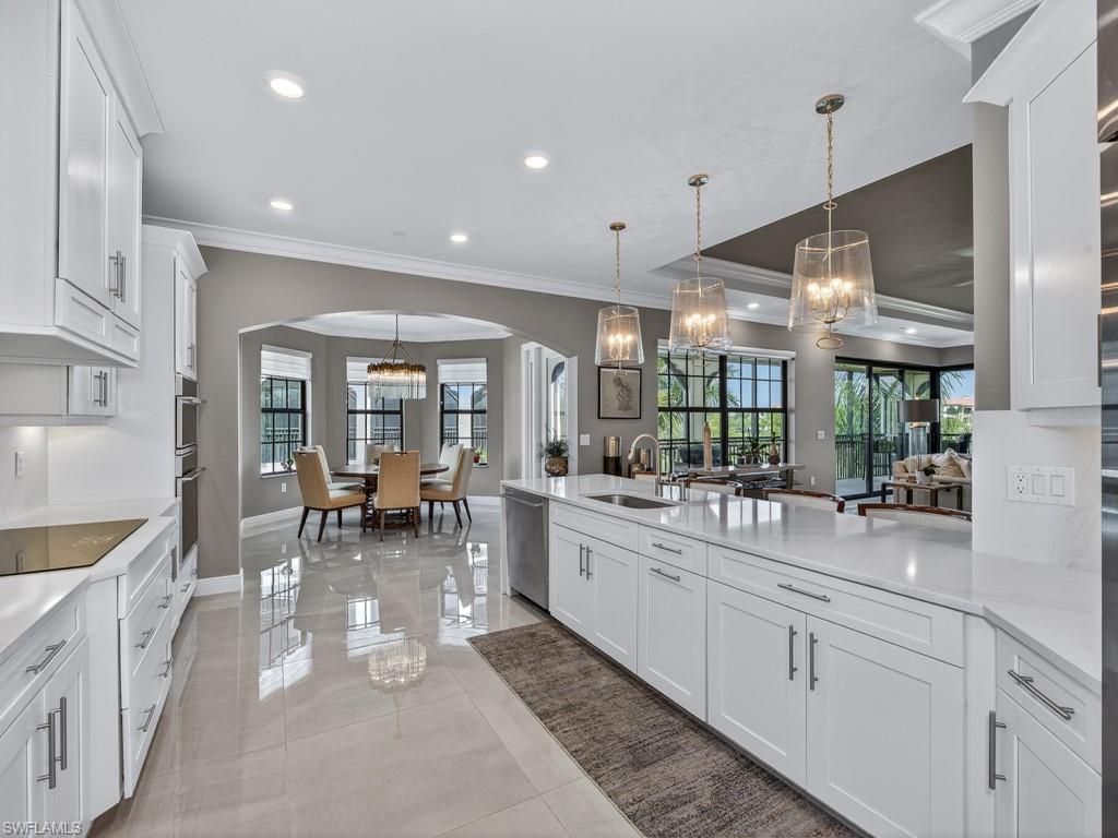16371 Viansa Way, Unit 201 Naples, FL 34110 - Photo 10 of 42 a kitchen with lots of counter top space and dining table