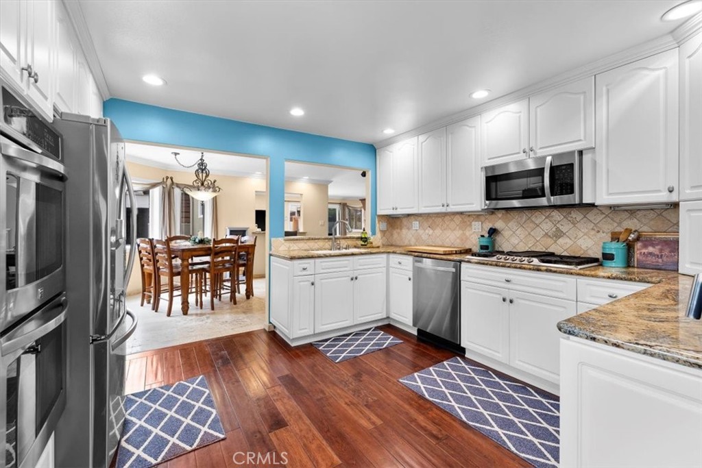 528 East 238th Place Carson, CA 90745 - Photo 11 of 75 a kitchen with stainless steel appliances granite countertop a stove a sink and a microwave