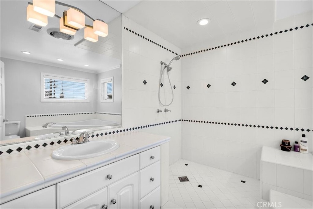 528 East 238th Place Carson, CA 90745 - Photo 20 of 75 a bathroom with a bathtub a shower a sink and mirror