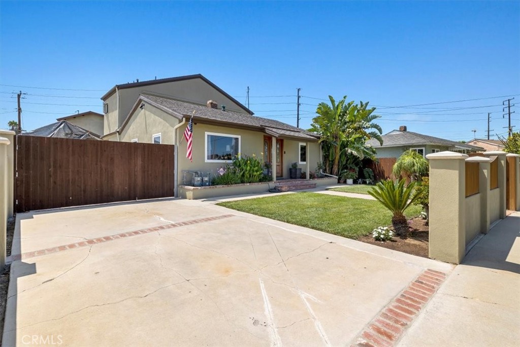 528 East 238th Place Carson, CA 90745 - Photo 3 of 75 a front view of a house with a yard and garage