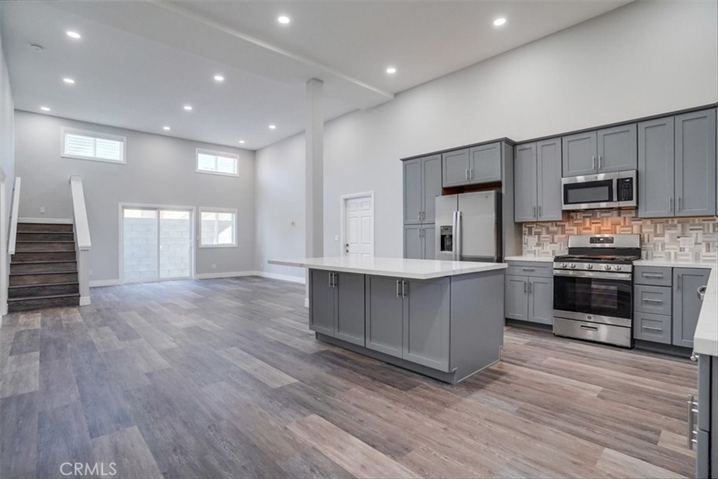 528 East 238th Place Carson, CA 90745 - Photo 40 of 75 a kitchen with kitchen island granite countertop a stove a sink and a refrigerator