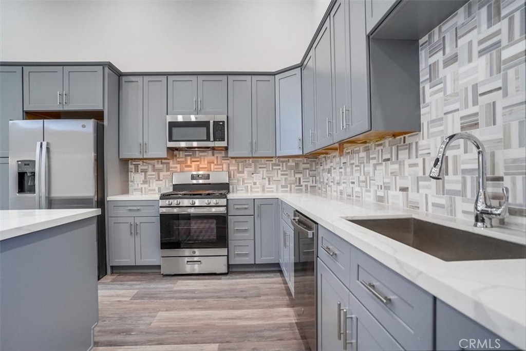 528 East 238th Place Carson, CA 90745 - Photo 41 of 75 a kitchen with granite countertop a sink stove and refrigerator