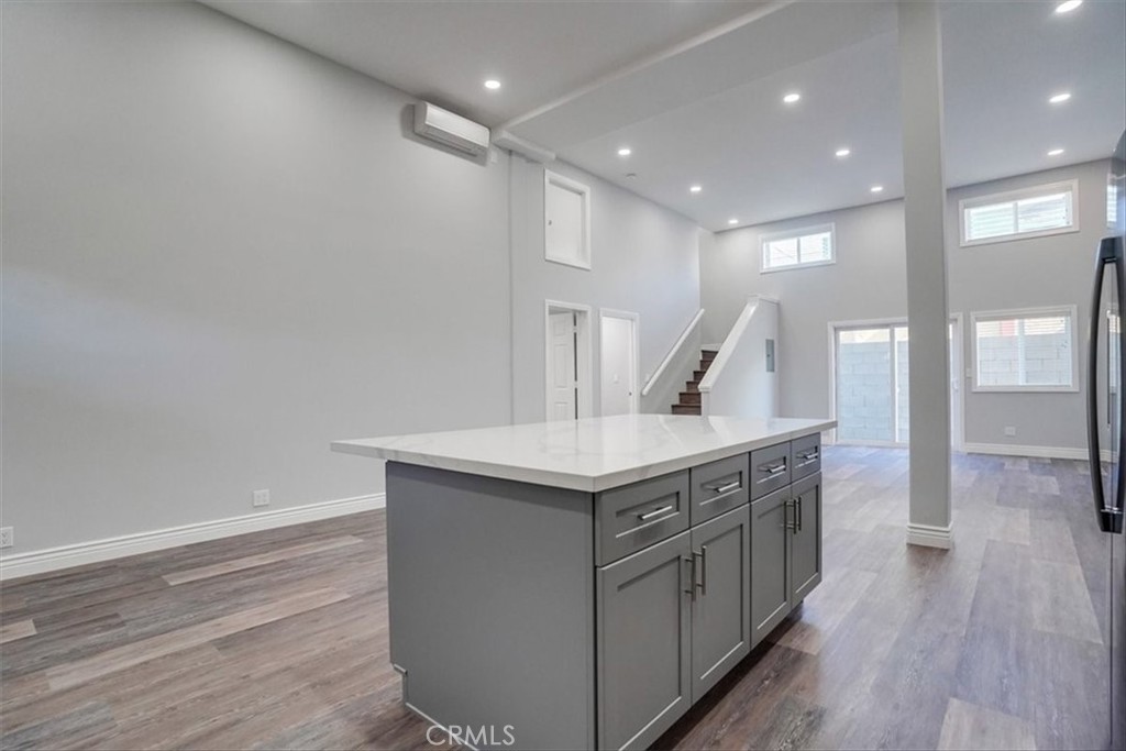 528 East 238th Place Carson, CA 90745 - Photo 44 of 75 a kitchen with stainless steel appliances granite countertop a wooden floor a large counter top and a wooden floors