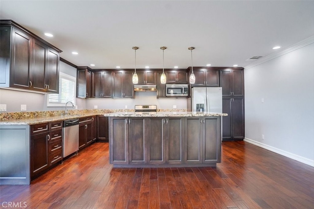 528 East 238th Place Carson, CA 90745 - Photo 65 of 75 a kitchen with stainless steel appliances granite countertop a stove a sink and a refrigerator