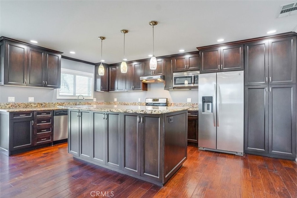 528 East 238th Place Carson, CA 90745 - Photo 66 of 75 a kitchen with stainless steel appliances granite countertop a refrigerator a sink a stove and a microwave