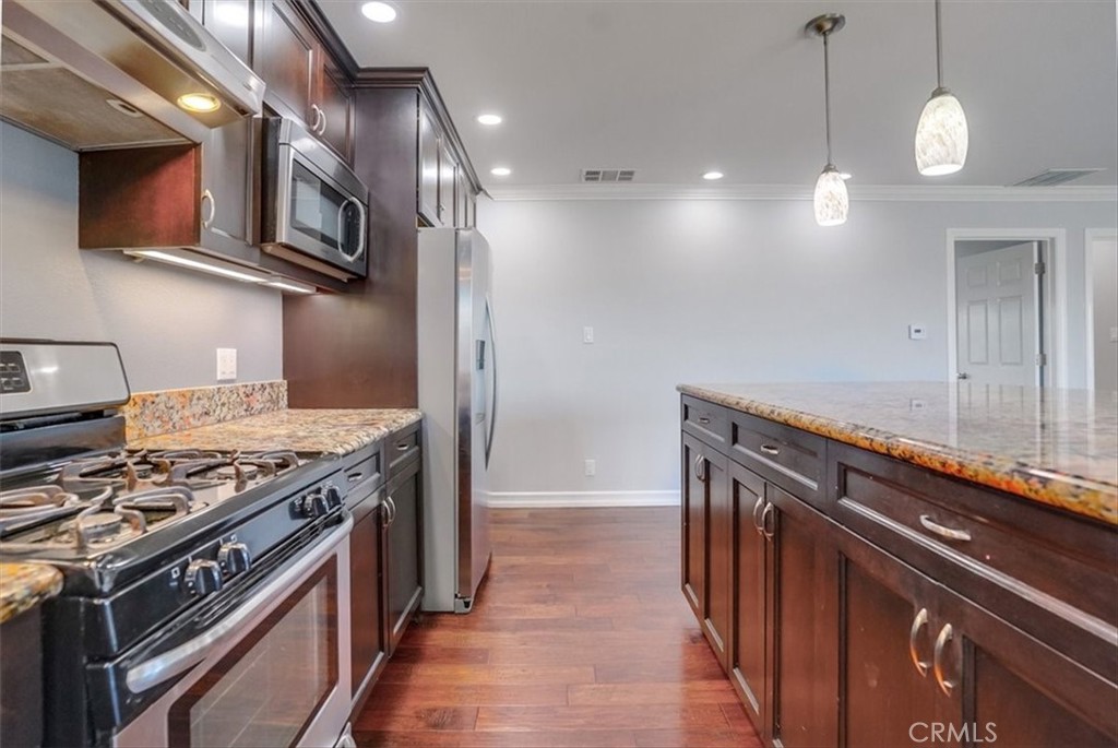 528 East 238th Place Carson, CA 90745 - Photo 68 of 75 a kitchen with a stove and a microwave
