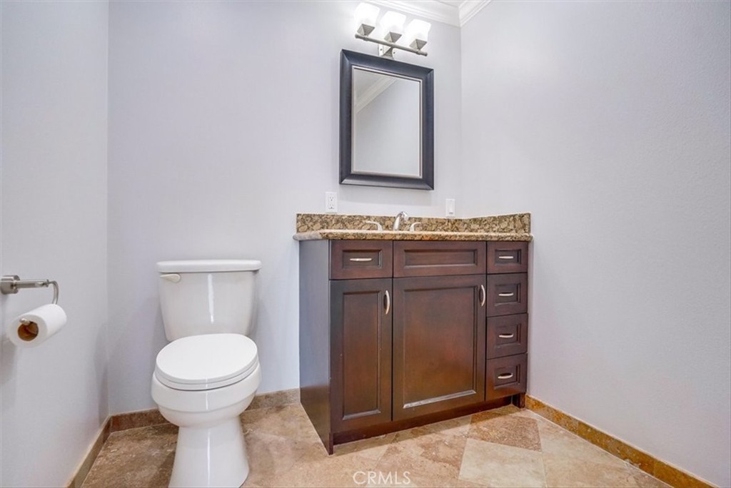 528 East 238th Place Carson, CA 90745 - Photo 69 of 75 a bathroom with a toilet a sink and mirror