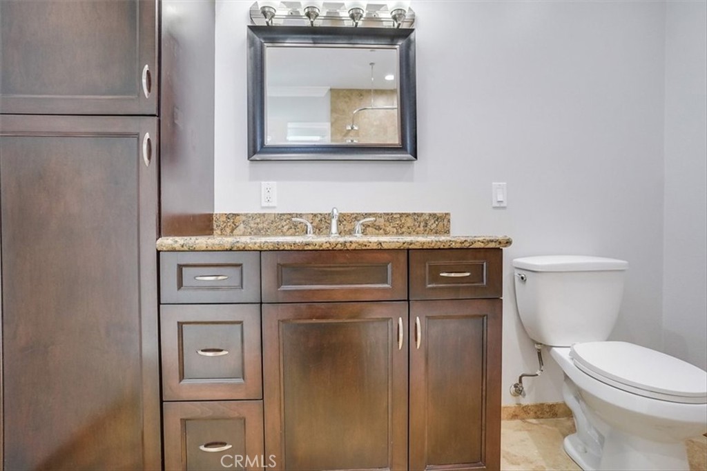 528 East 238th Place Carson, CA 90745 - Photo 73 of 75 a bathroom with a toilet sink and mirror