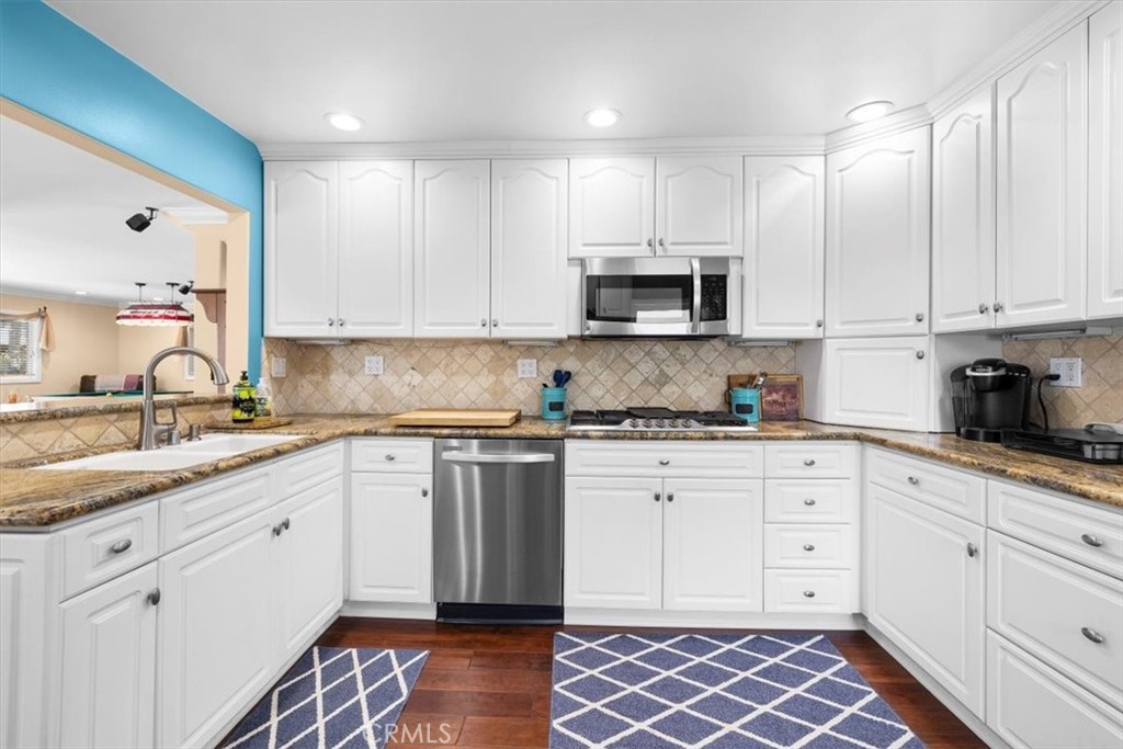 528 East 238th Place Carson, CA 90745 - Photo 9 of 75 a kitchen with stainless steel appliances granite countertop a sink and cabinets