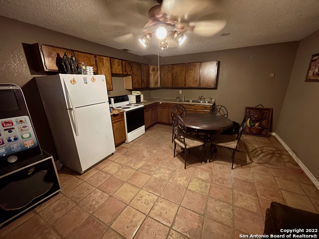 10671 Briggs Road Atascosa, TX 78002 - Photo 11 of 38 a kitchen with furniture a refrigerator and a sink