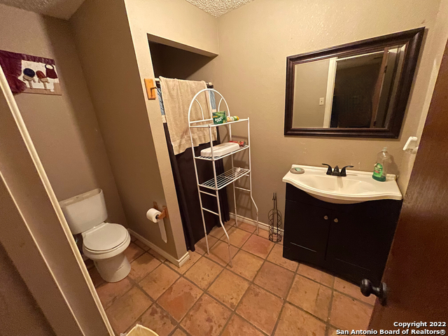 10671 Briggs Road Atascosa, TX 78002 - Photo 13 of 38 a bathroom with a sink a toilet and a mirror