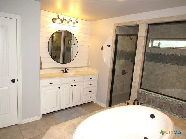 a bathroom with a sink a mirror and a bathtub