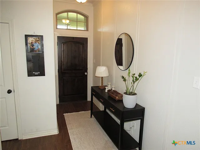 a living room with furniture and a mirror