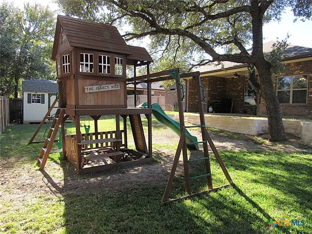 a view of a house with backyard and sitting area