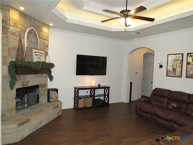 a living room with furniture a fireplace and a flat screen tv