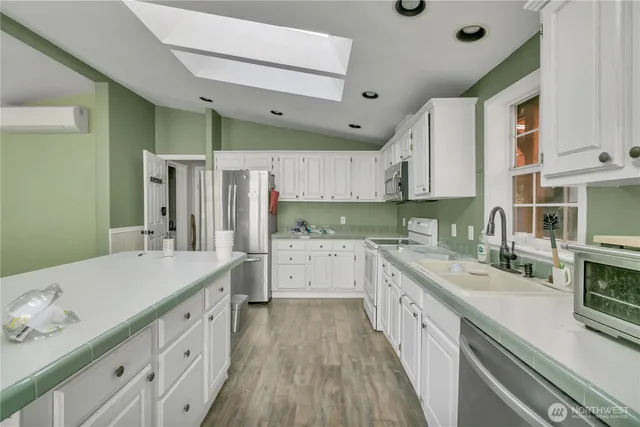 a large kitchen with a sink and cabinets