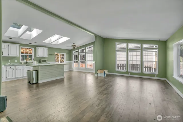 a view of a kitchen and window with wooden floor