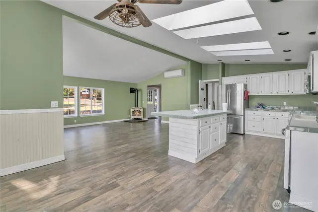 a kitchen with stainless steel appliances granite countertop a refrigerator and a stove