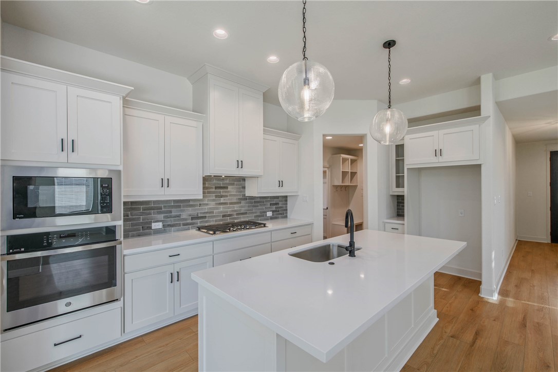 1652 Frontera Ranch Boulevard College Station, TX 77845 - Photo 12 of 29 a kitchen with a sink stainless steel appliances and white cabinets