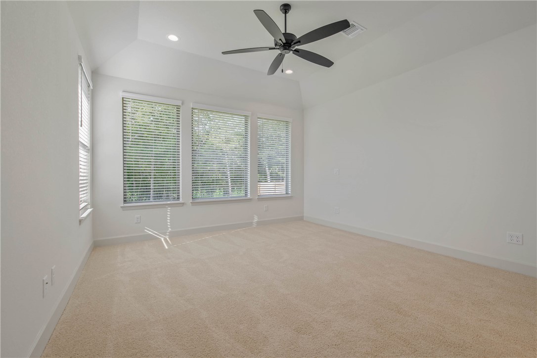 1652 Frontera Ranch Boulevard College Station, TX 77845 - Photo 13 of 29 an empty room with a ceiling fan and windows