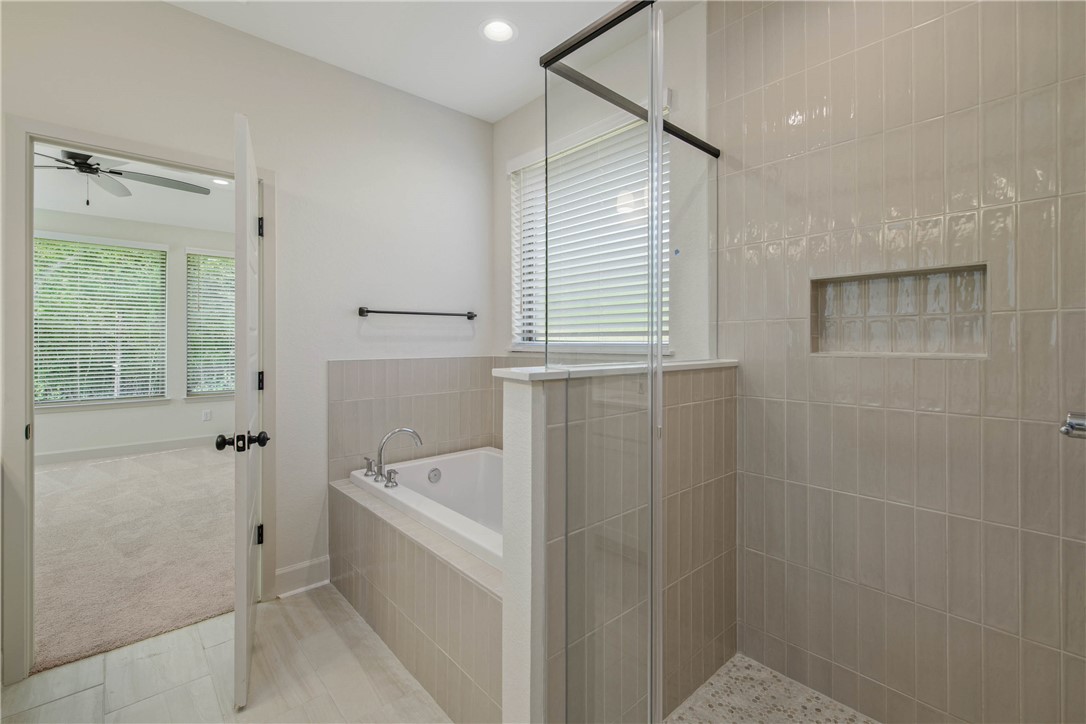 1652 Frontera Ranch Boulevard College Station, TX 77845 - Photo 16 of 29 a bathroom with a bathtub a toilet and a shower