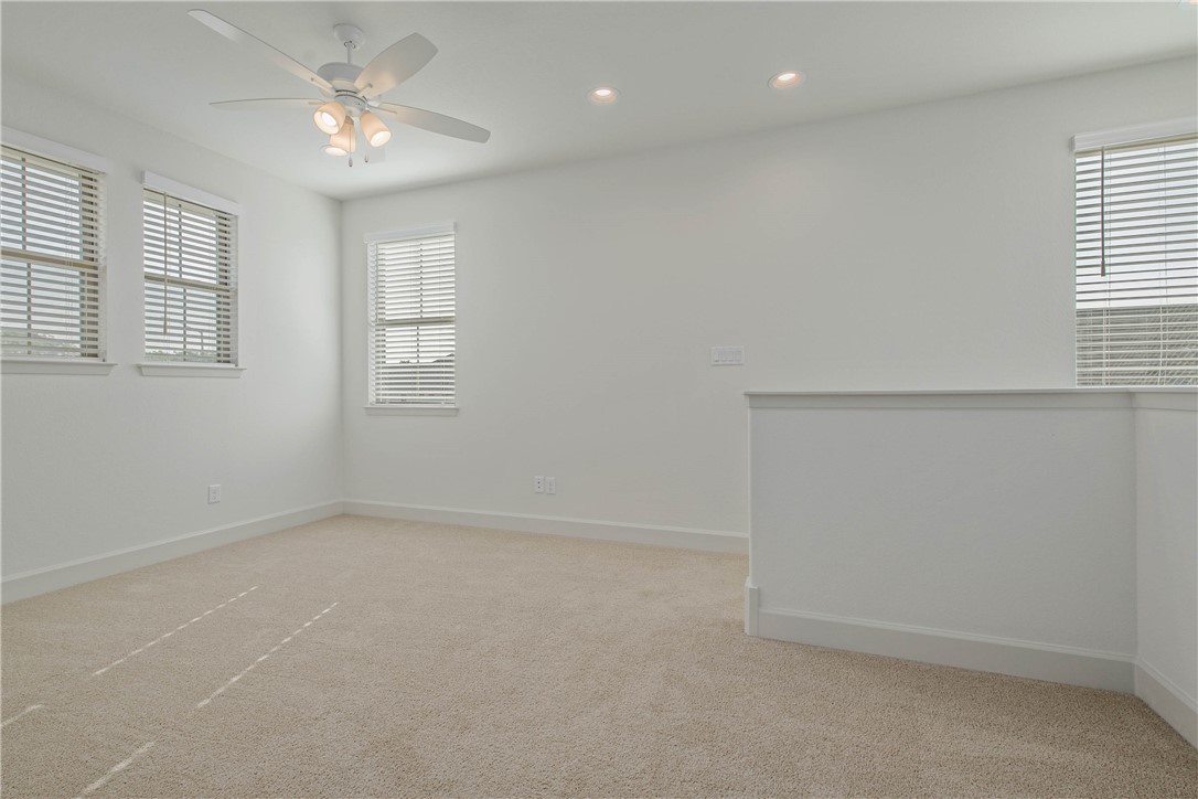 1652 Frontera Ranch Boulevard College Station, TX 77845 - Photo 19 of 29 an empty room with a window and a ceiling fan