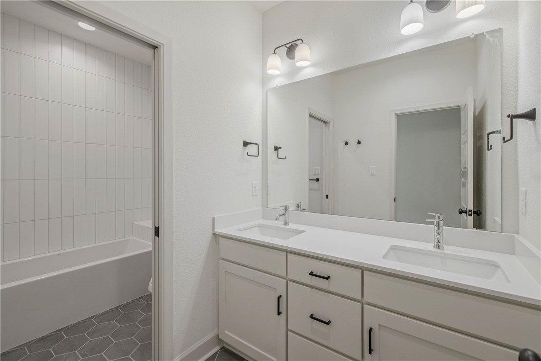 1652 Frontera Ranch Boulevard College Station, TX 77845 - Photo 21 of 29 a bathroom with a double vanity sink mirror double and bathtub