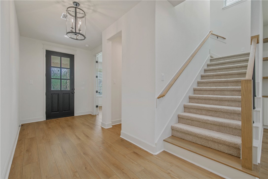 1652 Frontera Ranch Boulevard College Station, TX 77845 - Photo 3 of 29 a view of a hallway with wooden floor and entryway
