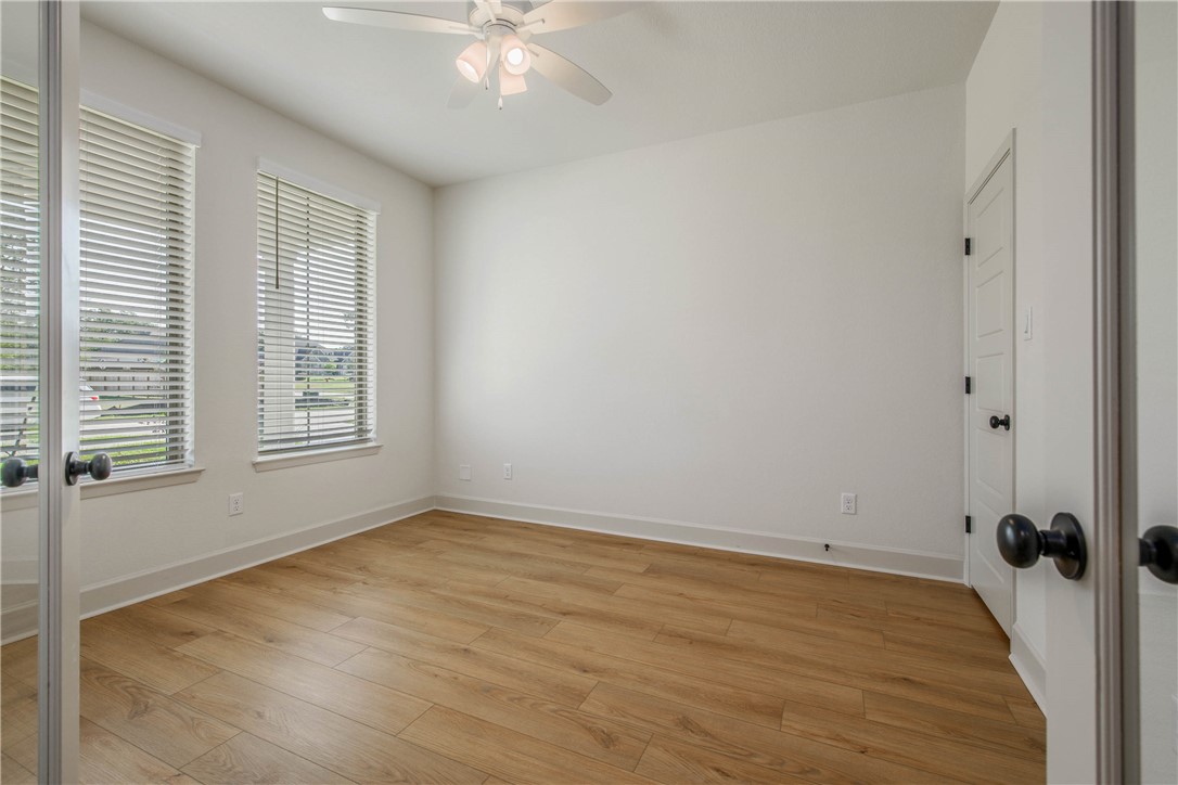 1652 Frontera Ranch Boulevard College Station, TX 77845 - Photo 4 of 29 wooden floor in an empty room with a window