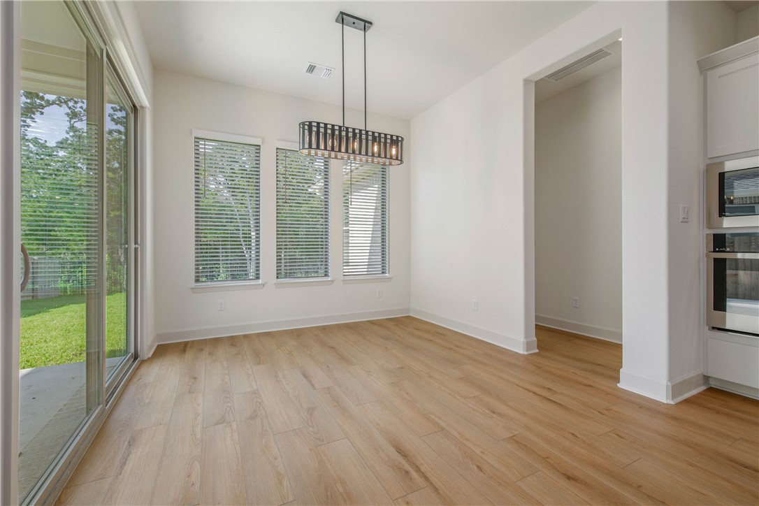 1652 Frontera Ranch Boulevard College Station, TX 77845 - Photo 7 of 29 a view of an empty room with wooden floor and a window