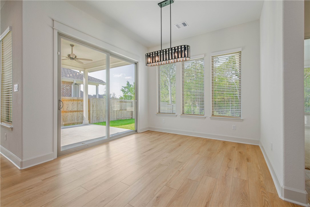 1652 Frontera Ranch Boulevard College Station, TX 77845 - Photo 8 of 29 a view of an empty room with wooden floor and a window