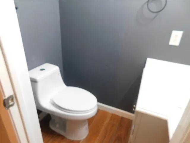 a white toilet sitting next to a white sink
