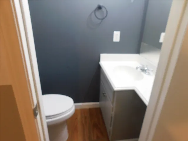 a white toilet sitting next to a white sink