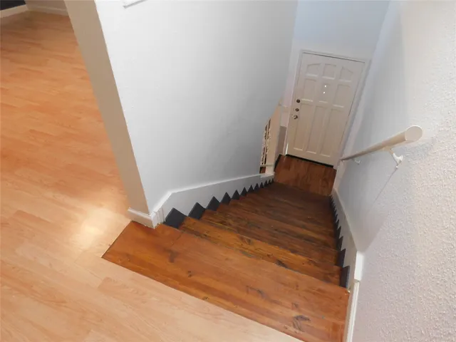 a view of a room with wooden floor