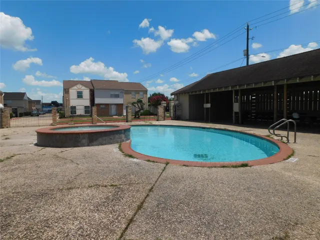 a view of a swimming pool with a patio