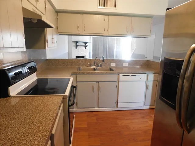 a kitchen with a sink a stove and refrigerator