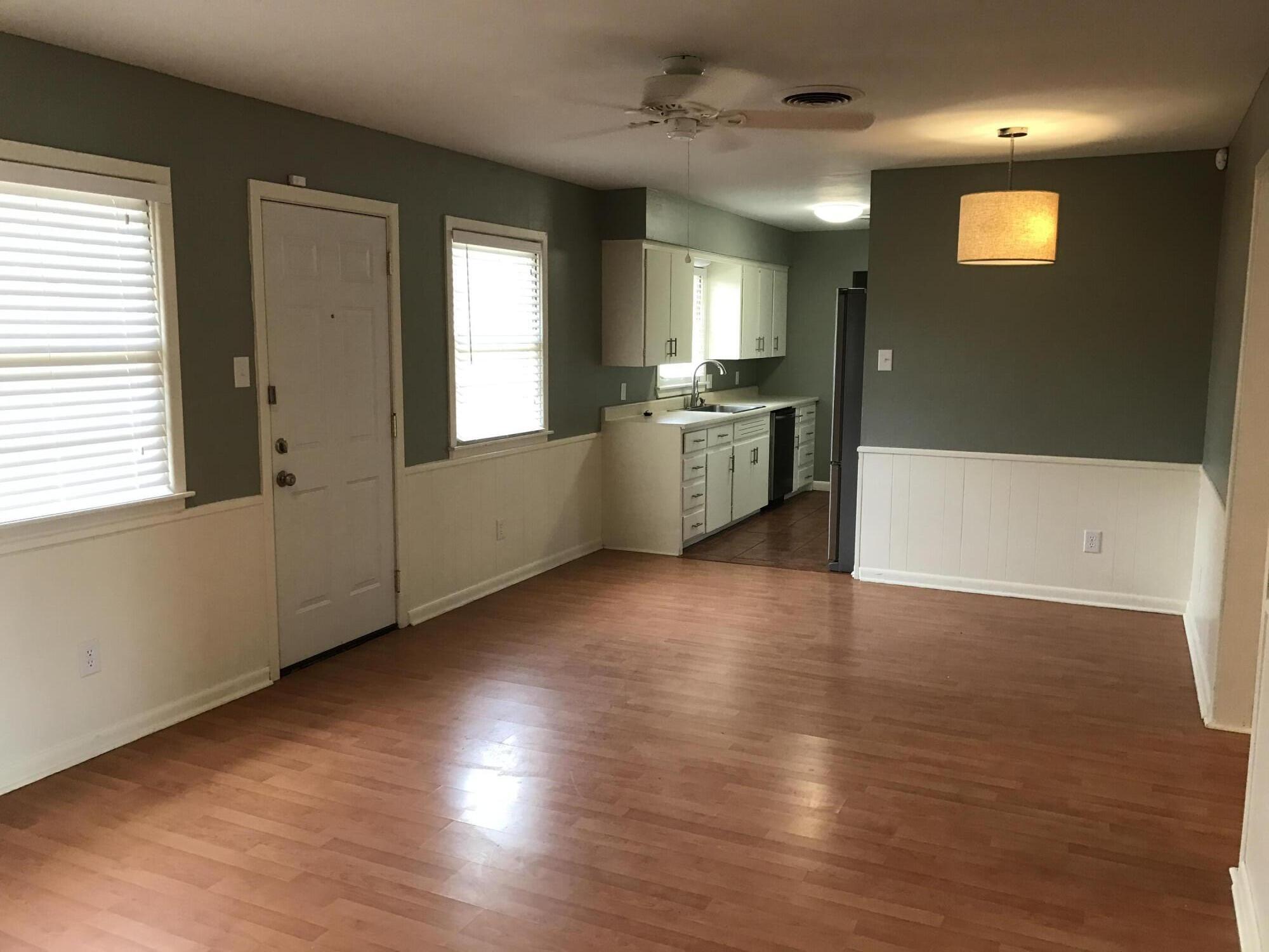 4409 27th Street Lubbock, TX 79410 - Photo 15 of 18 a view of a kitchen with a fridge and wooden floor